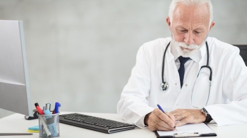 A lawyer organizing documents at a consultation desk to share through the portal