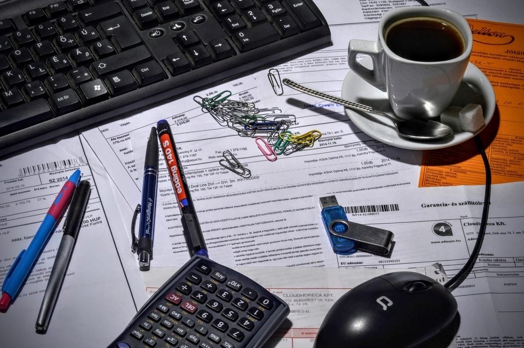 An invoice on a tidy desk beside a pen, ready to review and send to a client